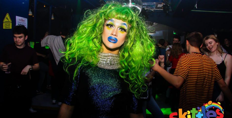 Image may contain: Wig, Costume, Light, Night Life, Night Club, Club, Hair, Human, Person