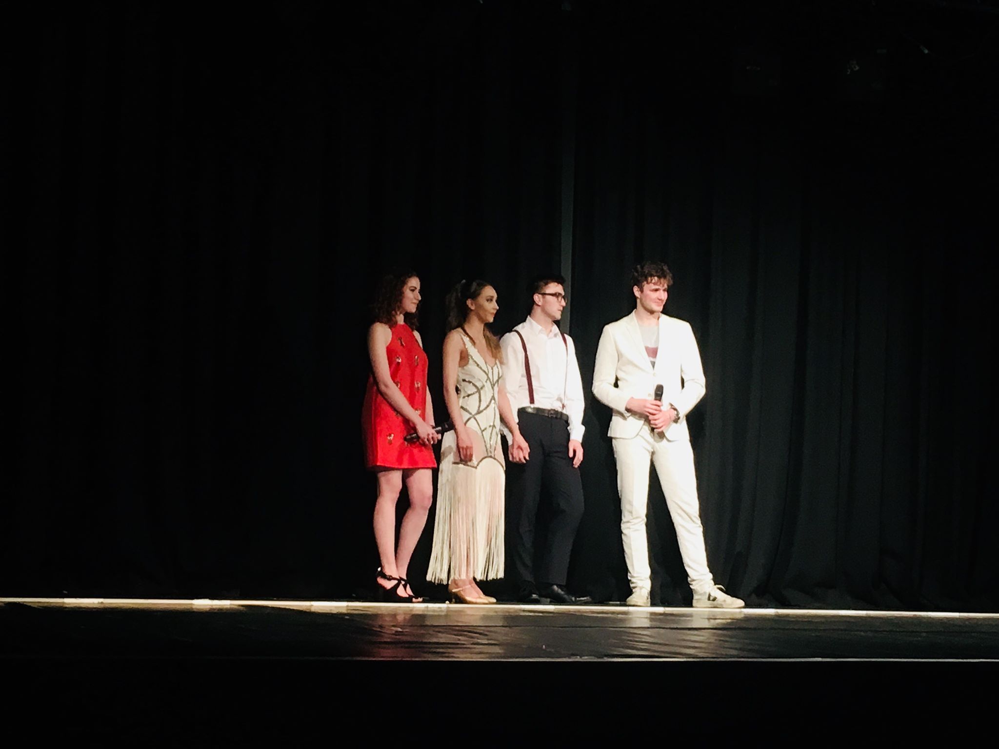 Image may contain: Stage, Suit, Overcoat, Coat, Clothing, Performer, Musical, Music, Leisure Activities, Person, People, Human