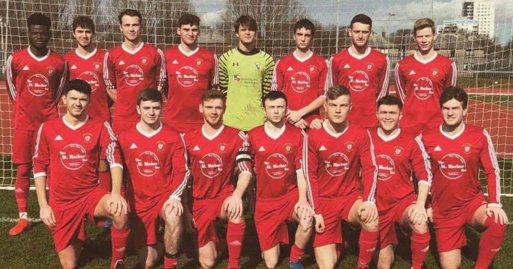 Image may contain: Ball, Jersey, Shirt, Sphere, Football, Team Sport, Team, Apparel, Clothing, Sport, Sports, Boy, People, Person, Human
