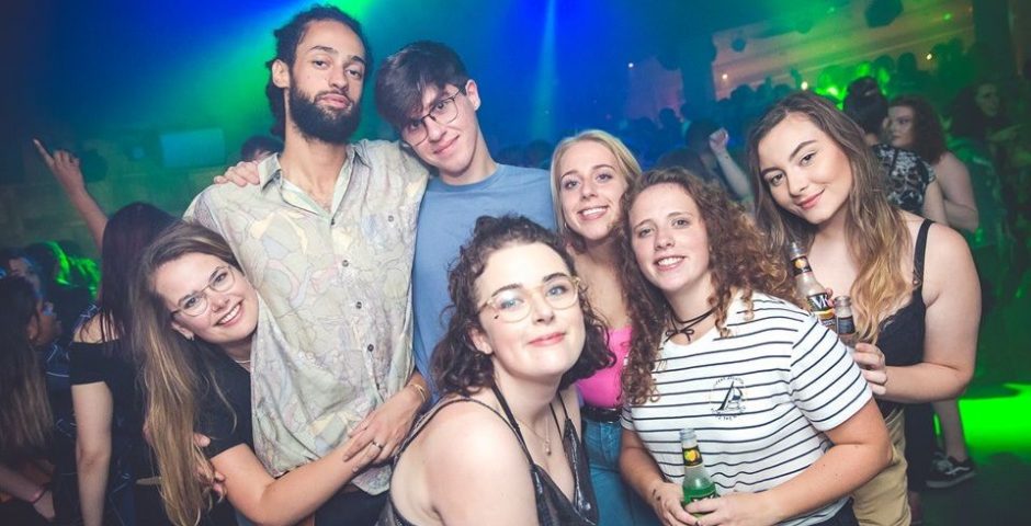 Image may contain: Beverage, Drink, Lighting, People, Female, Photo, Photography, Portrait, Accessory, Accessories, Glasses, Night Club, Night Life, Smile, Club, Face, Party, Person, Human