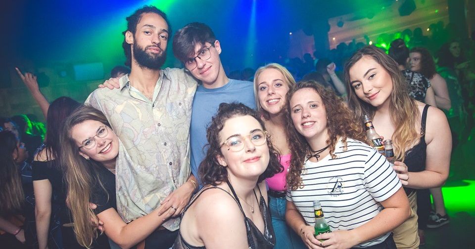 Image may contain: Beverage, Drink, Lighting, People, Female, Photo, Photography, Portrait, Accessory, Accessories, Glasses, Night Club, Night Life, Smile, Club, Face, Party, Person, Human