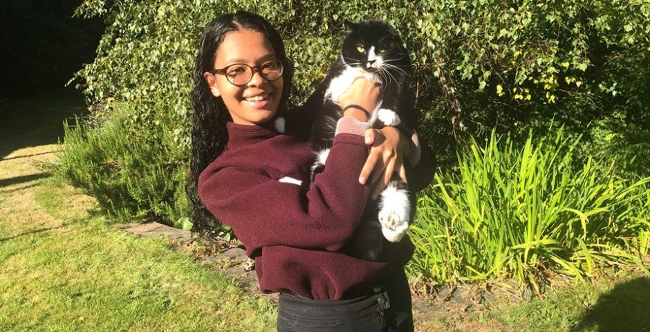 Image may contain: Portrait, Photo, Photography, Sweater, Girl, Tree, Pants, Bush, Animal, Pet, Cat, Mammal, Female, Face, Vegetation, Human, Person, Yard, Outdoors, Nature, Accessories, Accessory, Glasses, Plant, Grass, Clothing, Apparel