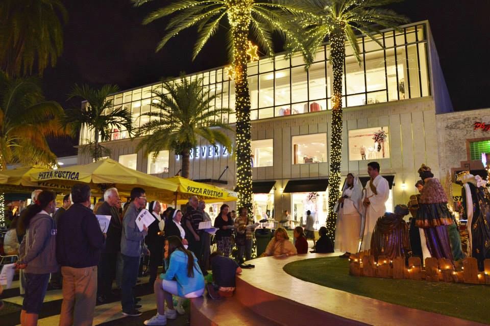Image may contain: Pedestrian, Shop, Shoe, Footwear, Crowd, Apparel, Clothing, City, Downtown, Town, Urban, Architecture, Palm Tree, Arecaceae, Building, Plant, Tree, Person, Human