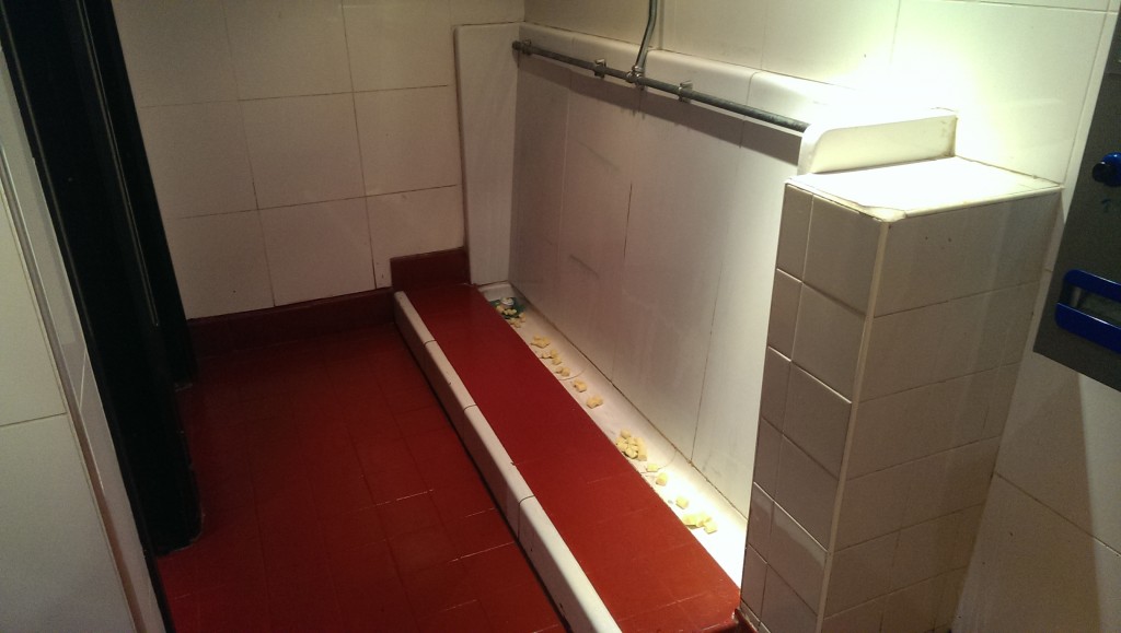 The 'trough' style of urinals.