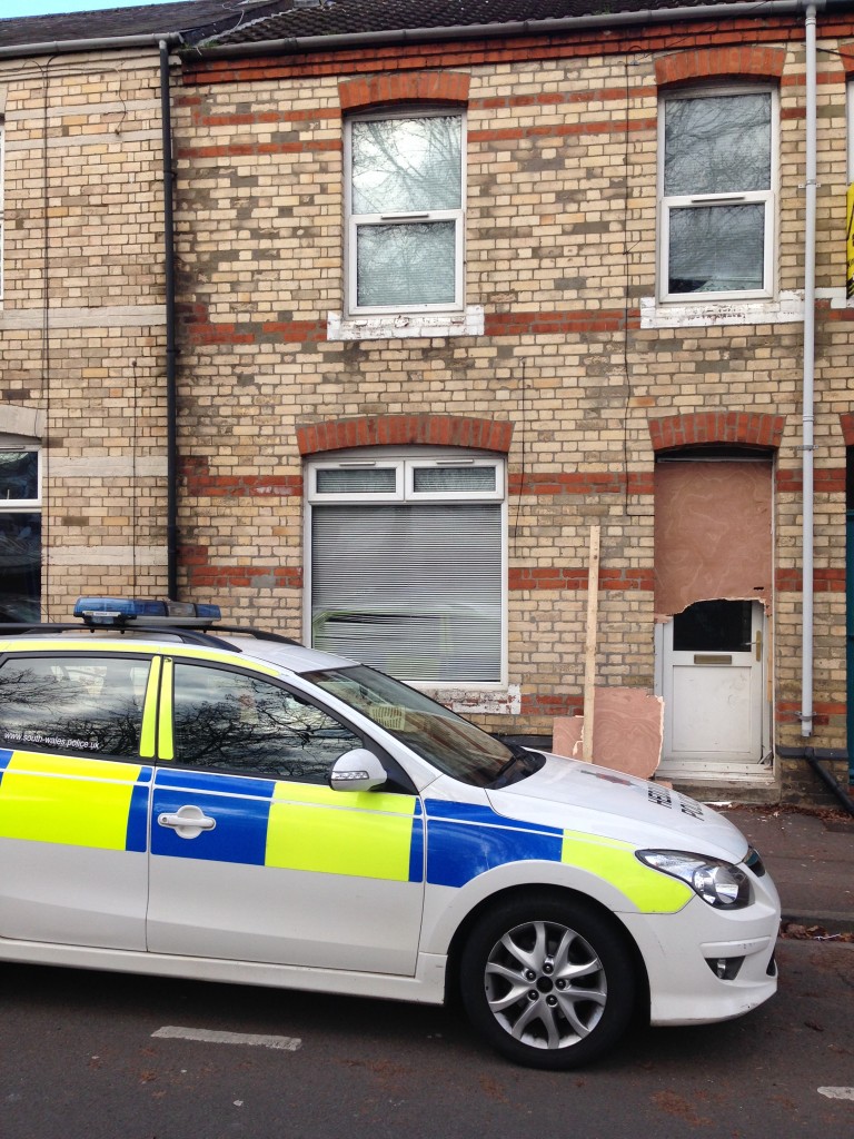 The front door was obviously damaged by the police ram.