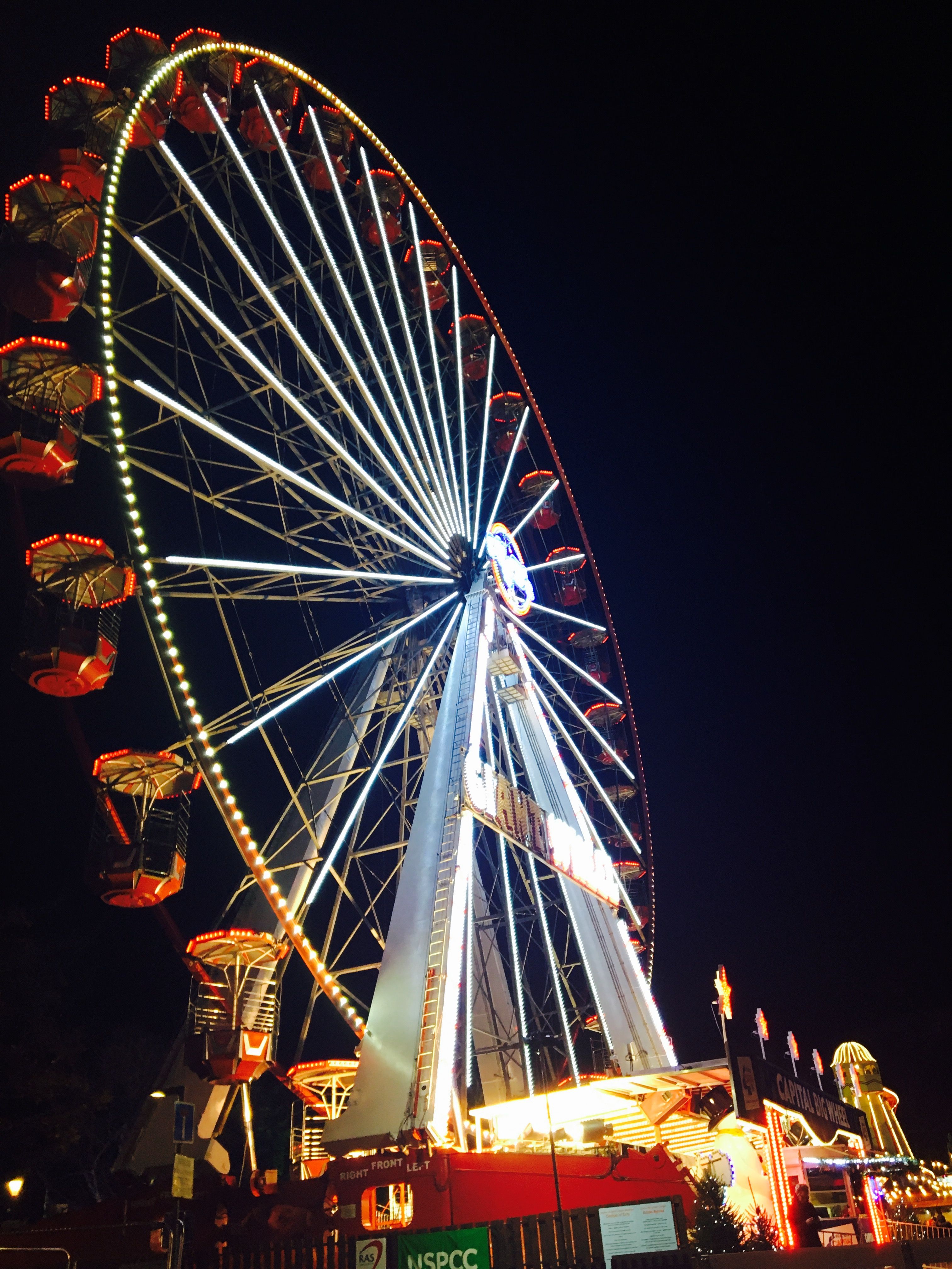 Image may contain: Constriction Crane, Person, Parade, Human, Crowd, Carnival, Leisure Activities, Ferris Wheel, Amusement Park