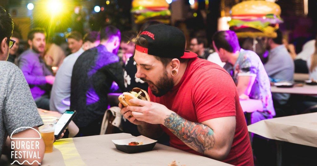 Image may contain: Eating, Food, Tattoo, Helmet, Clothing, Apparel, Skin, Person, Human