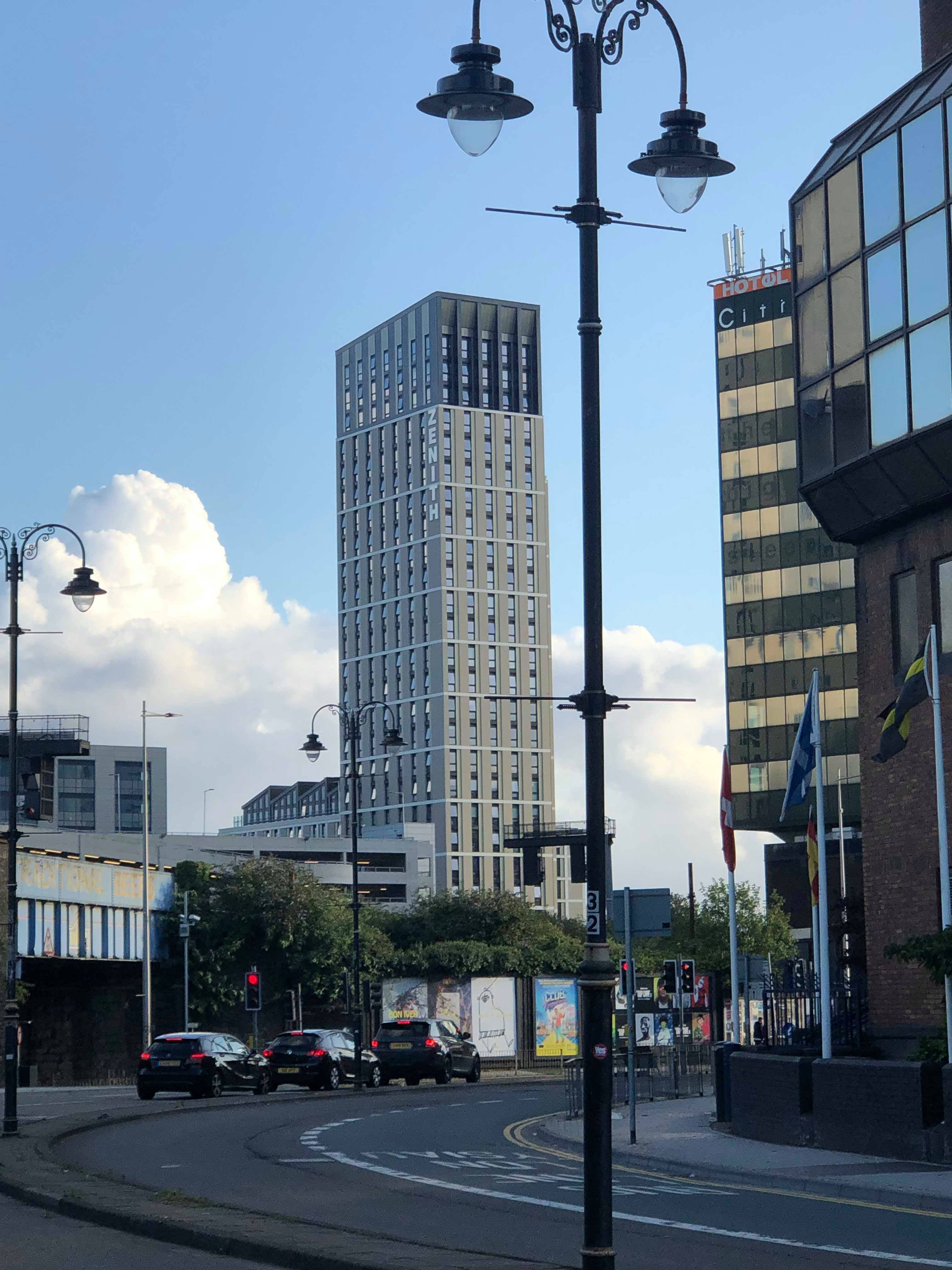 Image may contain: High Rise, Utility Pole, Road, Downtown, Urban, City, Town, Building, Office Building, Vehicle, Transportation, Car, Automobile, Lamp Post