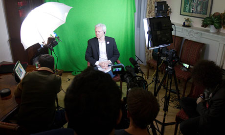 Assange addressed the Union via video link, a green screen at his back