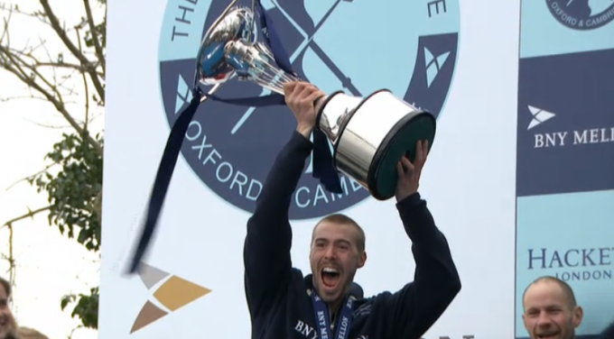 Boat Race disaster: Oxford's Alex Davidson holds the trophy aloft after the dark blues came out on top.