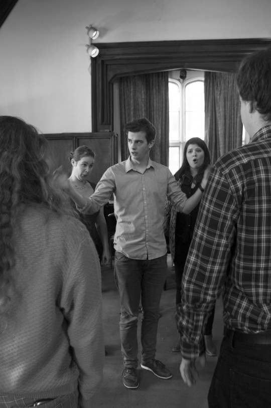 Musical director Benedict Kearns (centre) having a word with the cast