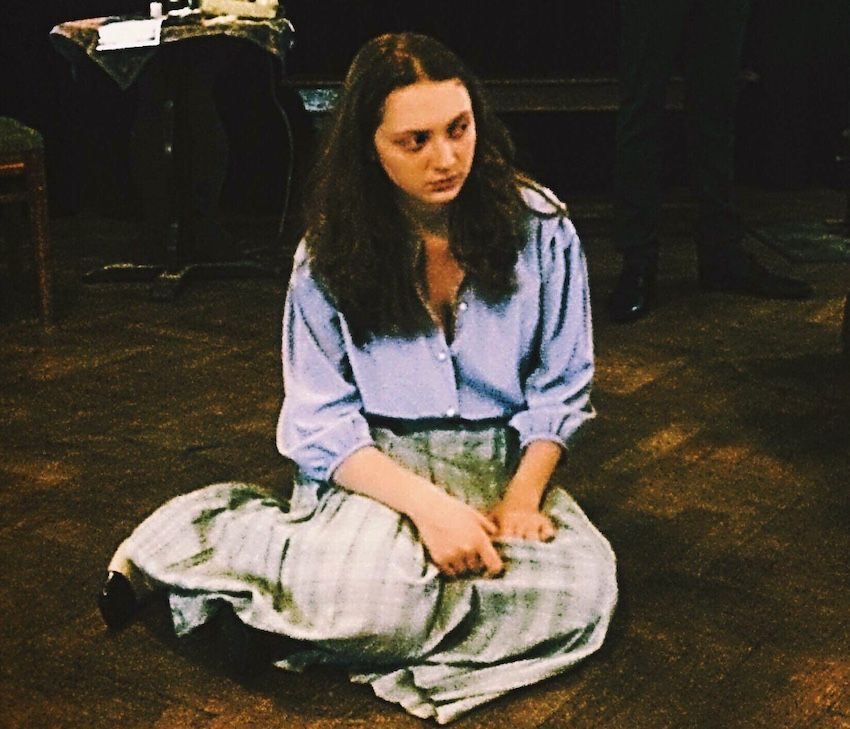 Image may contain: Female, Pants, Sitting, Clothing, Apparel, Person, Human