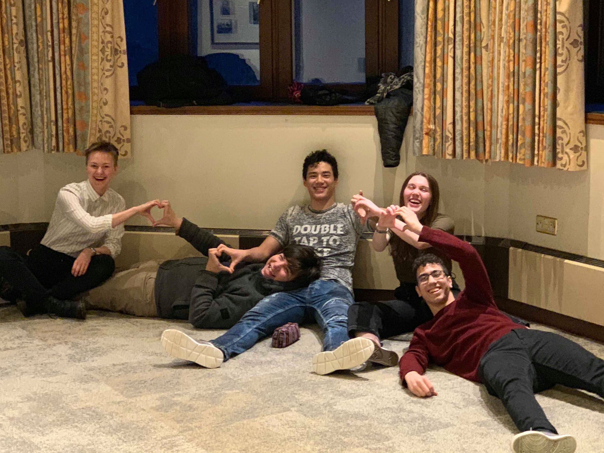 Image may contain: Floor, Flooring, Indoors, Room, Living Room, Wood, Pants, Couch, Furniture, Clothing, Footwear, Apparel, Shoe, Person, Sitting, Human