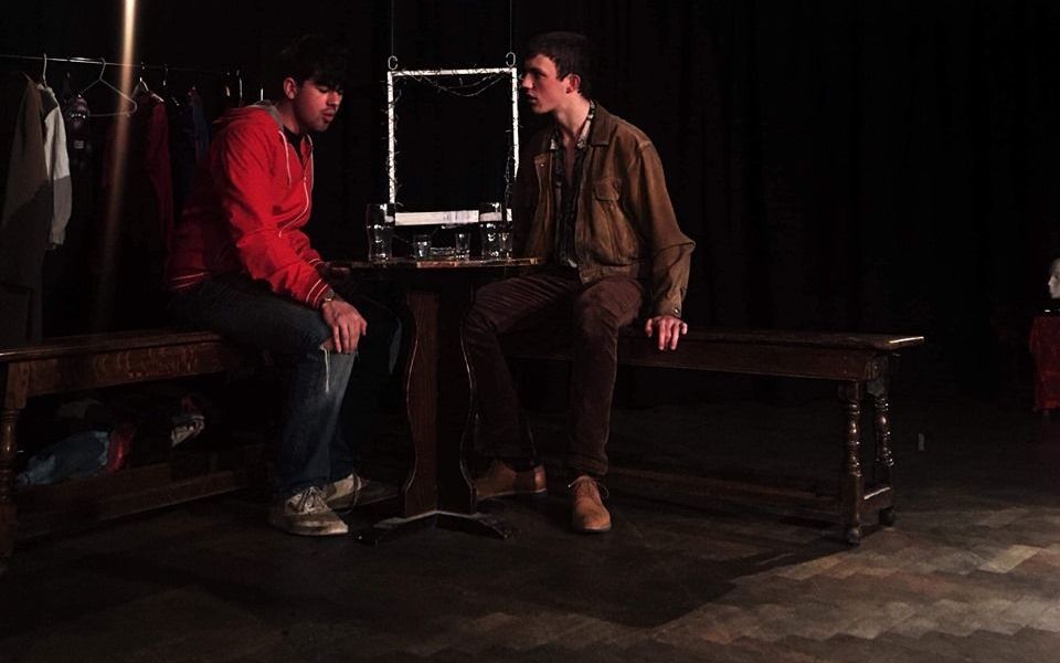 Image may contain: Man, Pants, Coat, Wood, Bench, Furniture, Sitting, Apparel, Clothing, Human, Person