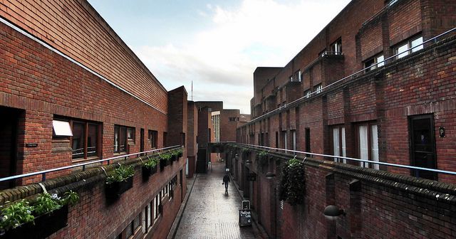 Image may contain: Neighborhood, Person, Human, Alley, Alleyway, Brick, Town, City, Road, Building, Street, Urban