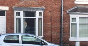 Image may contain: Van, Vehicle, Car, Automobile, Gutter, Brick, Window, Human, Person, People