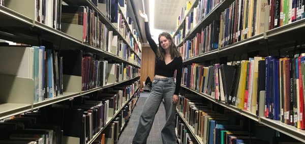 Image may contain: Aisle, Home Decor, Shelf, Furniture, Book, Library, Room, Indoors, Person, Human