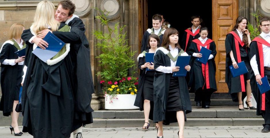 Image may contain: Pants, Outdoors, Blossom, Flower, Female, Coat, Suit, Overcoat, Vegetation, Potted Plant, Pottery, Jar, Vase, Plant, Footwear, Shoe, Graduation, Apparel, Clothing, Person, Human