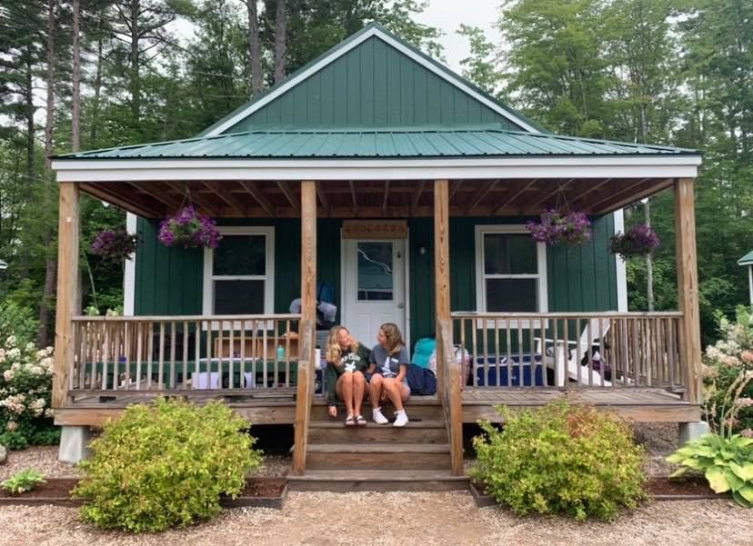 Image may contain: Hut, Yard, Neighborhood, Urban, Vegetation, Bush, Plant, Cabin, Porch, Human, Person, Rural, Outdoors, Nature, Shelter, Countryside, House, Cottage, Housing, Building