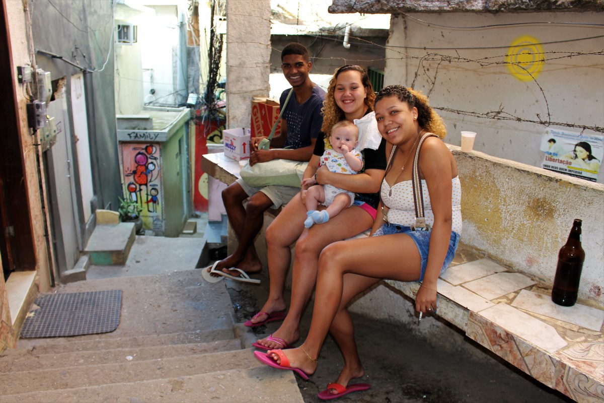 Mary and her friends sitting on a staircase in Vidigal