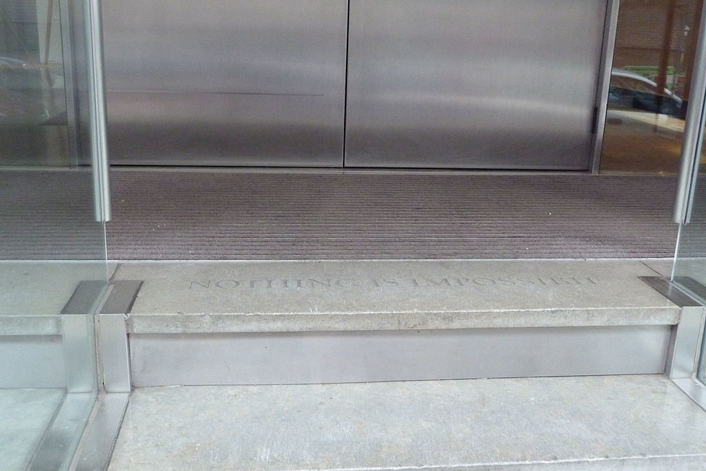 The words 'nothing is impossible' are engraved outside Saatchi's London office
