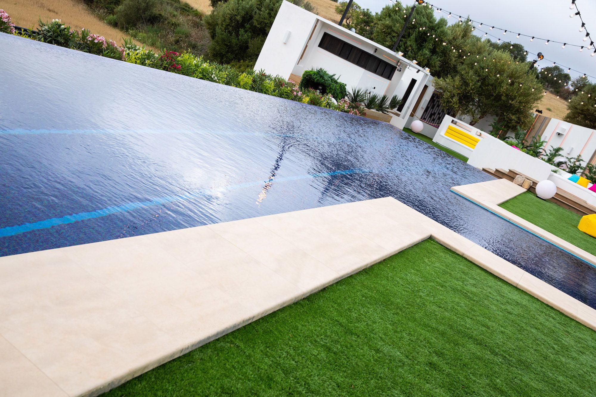 Image may contain: Love Island villa, Love Island 2019, villa, location, inside, first look, Sant Llorenç des Cardassar, Majorca, Outdoors, Hotel, Rug, Swimming Pool, Building, Pool, Water, Grass, Plant