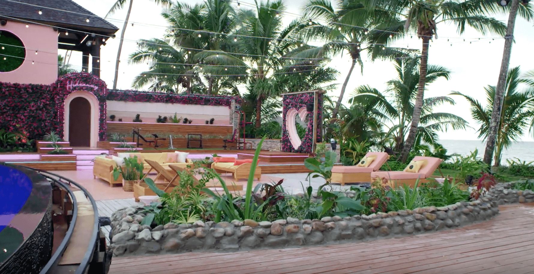 Image may contain: Love Island USA villa, Love Island USA, villa, Love Island, outside, decking, seating, gym, palm trees, hideaway, sunbed, CBS, Building, Hotel, Flagstone, Arbour, Garden, Outdoors