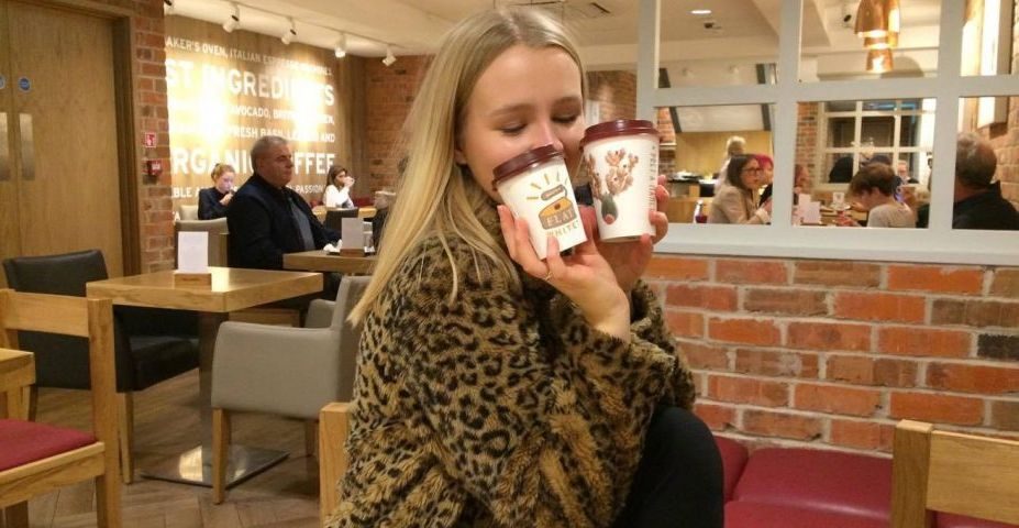 Image may contain: Coat, Alcohol, Beer, Drink, Beverage, Female, Coffee Cup, Cup, Dating, Cafe, Face, Restaurant, Clothing, Apparel, Human, Person, Furniture, Chair