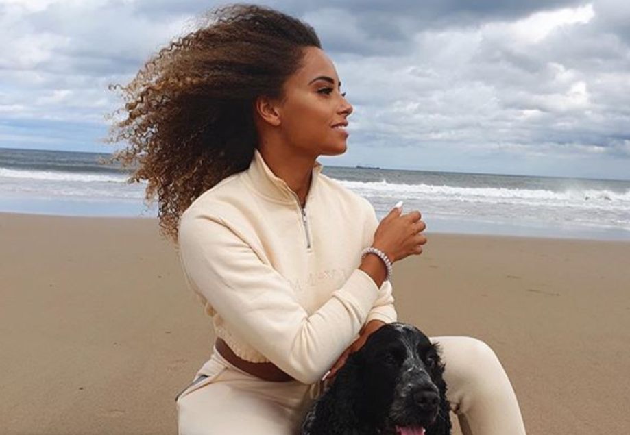 Image may contain: Woman, People, Sand, Beach, Coast, Shoreline, Pet, Canine, Animal, Mammal, Female, Sea, Nature, Outdoors, Water, Ocean, Face, Person, Human