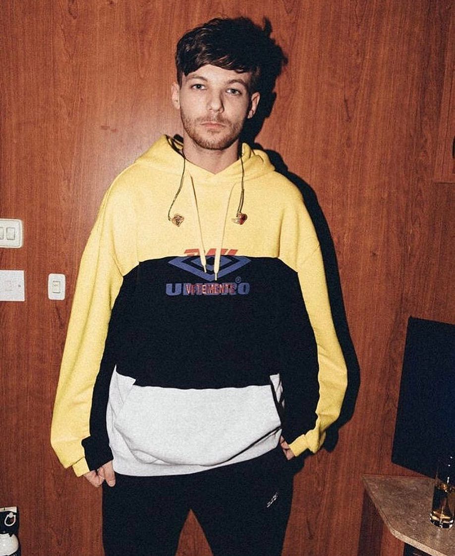 Image may contain: reality TV rich list, UK, reality TV, net worth, earnings, money, salary, rich, worth, Louis Tomlinson, One Direction, 1D, X Factor, Sweater, Sweatshirt, Plywood, Hardwood, Sleeve, Long Sleeve, Person, Human, Wood, Clothing, Apparel