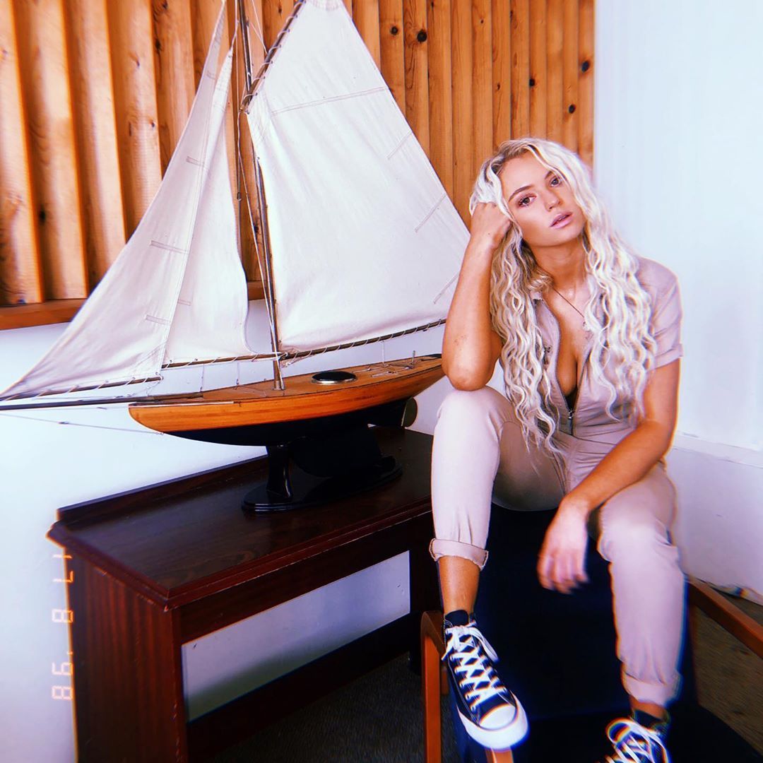 Image may contain: Love Island 2019 contestants, Love Island, 2019, now, job, Instagram, updates, news, latest, series five, Lucie Donlan, Tent, Plywood, Running Shoe, Shelf, Furniture, Hardwood, Person, Human, Wood, Footwear, Shoe, Clothing, Apparel