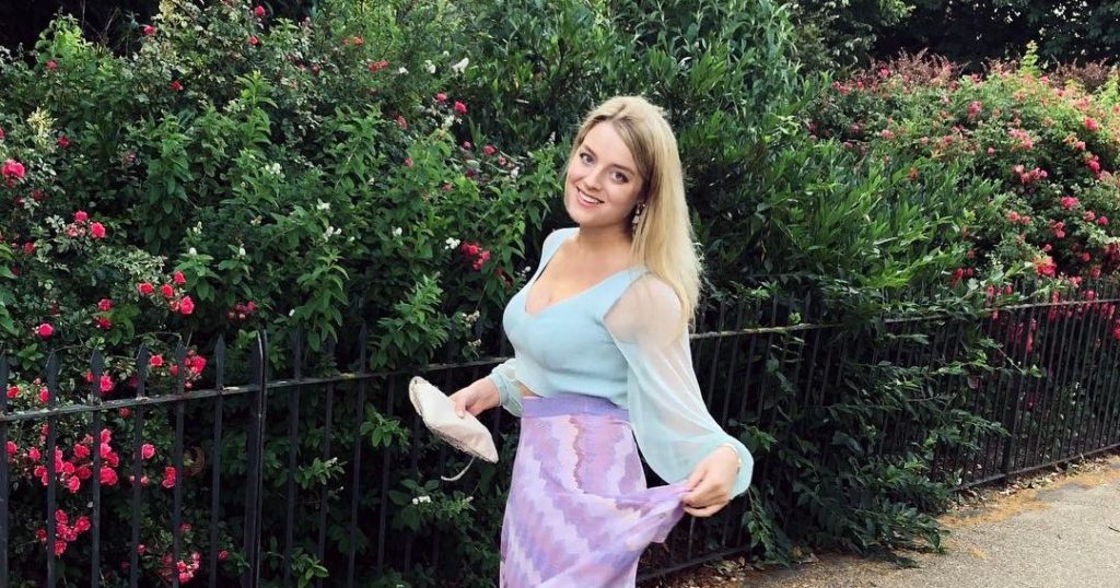 Image may contain: Flower, Blossom, Girl, Grass, Jar, Pottery, Vase, Potted Plant, Tree, Skirt, Outdoors, Nature, Yard, Woman, Dress, Bush, Plant, Vegetation, Female, Human, Person, Clothing, Apparel