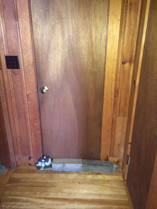 My impenetrable mouse barricade made out of a door stopper and wood blocks