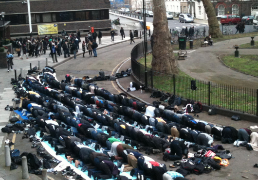 Students praying outside of City University London...