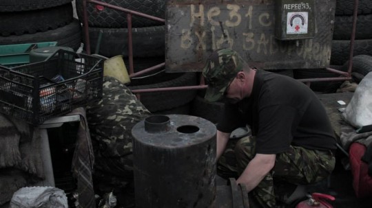 Preparing the molotov cocktails. Although many groups, both nationalists and far right remain armed on the streets of Kiev, these men only have molotov cocktails