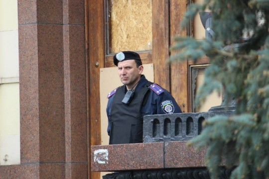 A police officer stands guard outside of the government building in Kharkiv. The windows had been broken in gunfights with pro-Russia gunmen who briefly occupied the building. They didn't like filming..
