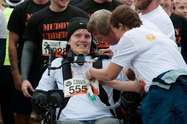 Rob Camm takes part in the Tough Mudder event at Cirencester Park, Cirencester, England. August 23 2015. Camm is the first tetraplegic in the world to take part in a Tough Mudder event which he navigated using a special wheelchair controlled by his chin and accompanied by a team of friends and family. See SWNS story SWROBO; A student has become the world's first tetraplegic to take part in Tough Mudder - navigating the gruelling 12-mile course in a pioneering wheelchair he controls with his CHIN. Rob Camm, 21, was paralysed in a car crash two years ago which left him with no movement in his body from the neck down just a week before he was due to start university. Last month, he became the first tetraplegic in the world who is reliant on a ventilator to learn how to walk again using a robotic skeleton controlled by his THOUGHTS. Now, he has taken part in the notorious Tough Mudder challenge - dubbed 'probably the toughest event on the planet' - in an off-road wheelchair set on top of a QUAD BIKE.