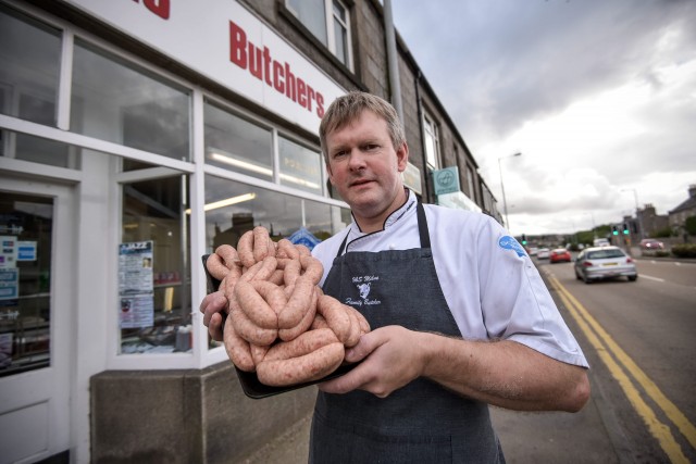 Kenny Milne, owner of H & S Milne & Sons Butchers, is pictured with his JÃgerbomb sausages at his shop in Aberdeen, Scotland. The sausages have proved to be a popular hit with locals. A Scots butcher has created the perfect hangover cure for a night of too many Jaegerbombs à Jaegerbomb sausages. See CENTRE PRESS story CPSAUSAGE; H & S Milnes Butchers in Inverurie, on the outskirts of Aberdeen have been struggling to keep up with demand after creating the sausage at the end of last week. The Jaegerbomb sausage consists of minced pork, seasoning, breadcrumbs, Jaegermeister and Red Bull. Since posting the sausages onto Facebook they have been viewed over 17,000 times.
