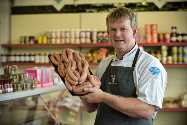 Kenny Milne, owner of H & S Milne & Sons Butchers, is pictured with his JÃgerbomb sausages at his shop in Aberdeen, Scotland. The sausages have proved to be a popular hit with locals. A Scots butcher has created the perfect hangover cure for a night of too many Jaegerbombs à Jaegerbomb sausages. See SWNS story SWSAUSAGE; H & S Milnes Butchers in Inverurie, on the outskirts of Aberdeen have been struggling to keep up with demand after creating the sausage at the end of last week. The Jaegerbomb sausage consists of minced pork, seasoning, breadcrumbs, Jaegermeister and Red Bull. Since posting the sausages onto Facebook they have been viewed over 17,000 times.