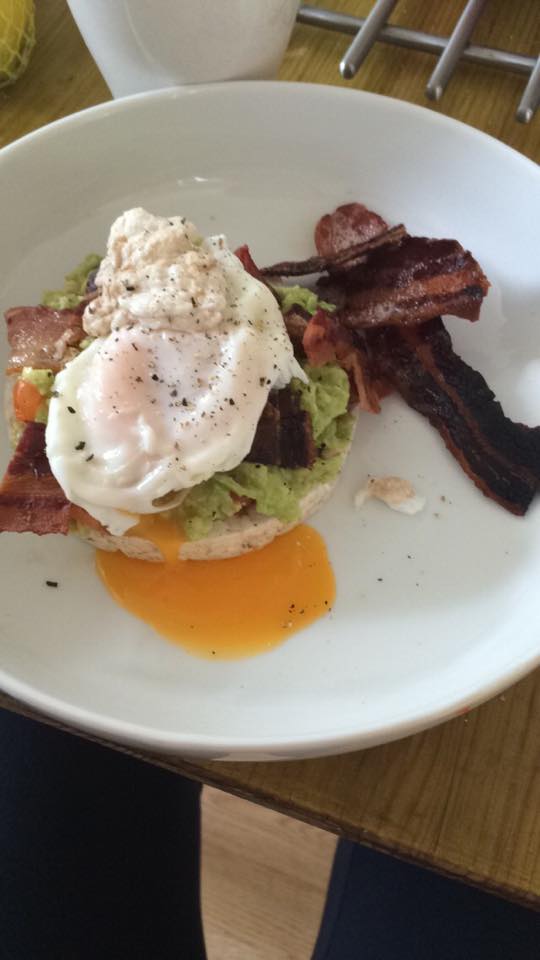 Eleni's guacamole on a rice cake with a poached egg and bacon
