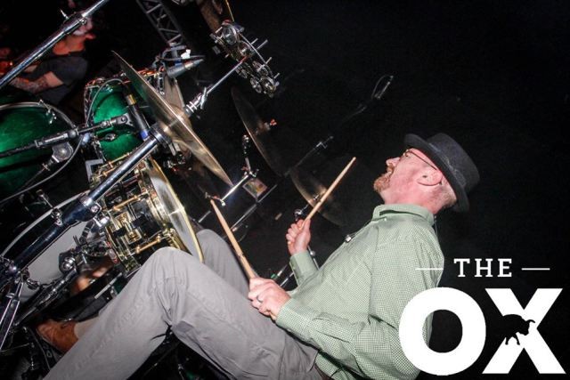 Looks like Walter White and plays the drums